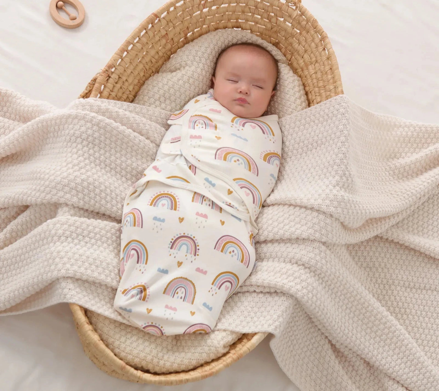 Featuring Newborn Sleep Swaddle in Rainbow